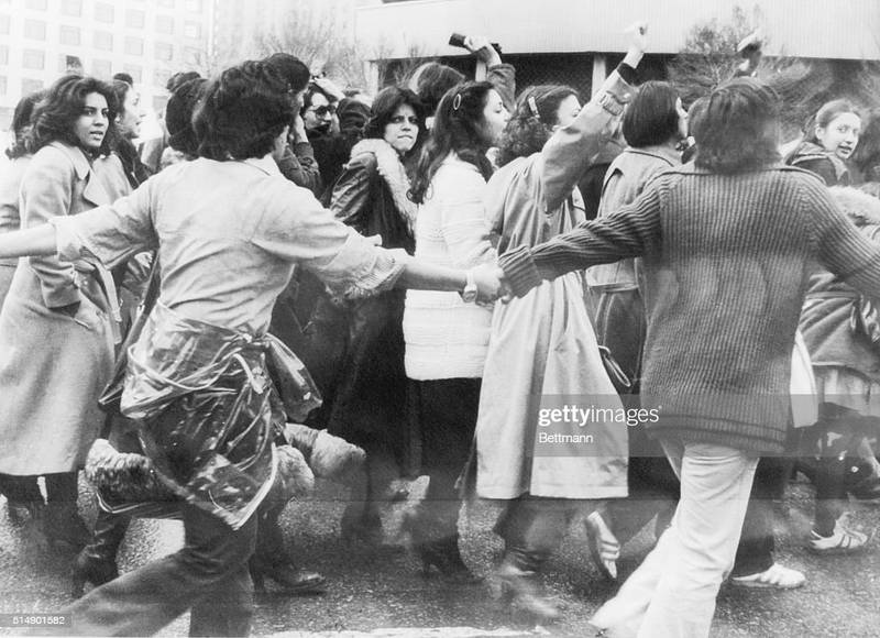 Protesters against the veil, protected by young men, march in central Tehran on March 10th, the third day of demonstrations for women's rights in the Islamic Republic of Ayatollah Khomeini. Getty Images