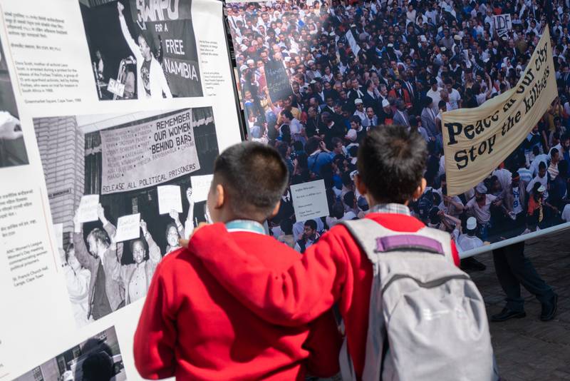 Nepali school children engage with Martyrs, Saints and Sell-outs at PhotoKTM6 in Patan. Curated by Siona O’Connell, the exhibition brings together photographs by Benny Gool, Zubeida Vallie, and Adil Bradlow documenting South Africa’s anti-apartheid struggle. Photo: Phoebe Chen