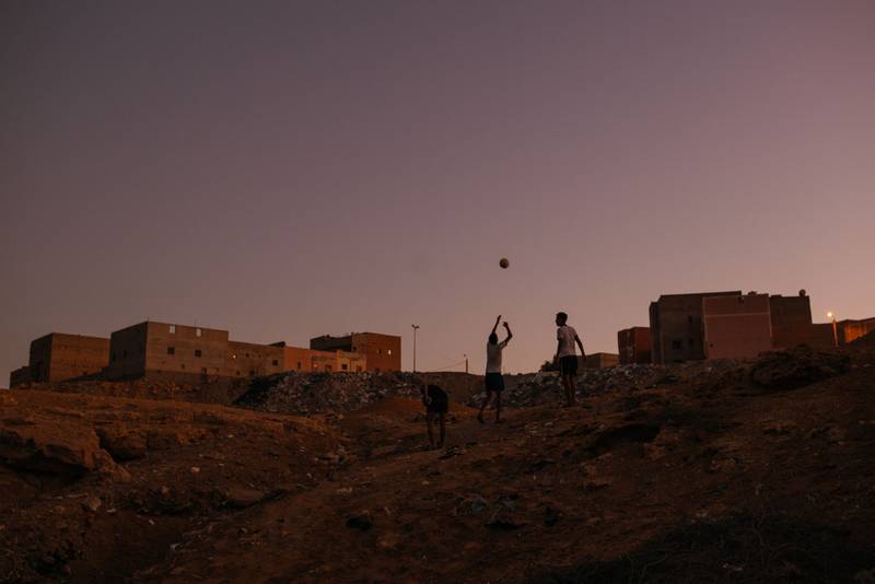 Sahrawi boys go home after an afternoon of playing football in the Sahara desert.